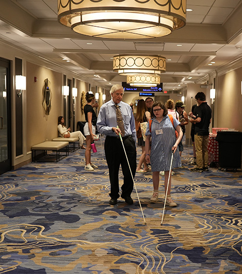 Jeff Altman gives an O&M lesson to Rebecca Godwin during the NOPBC Cane Walk.